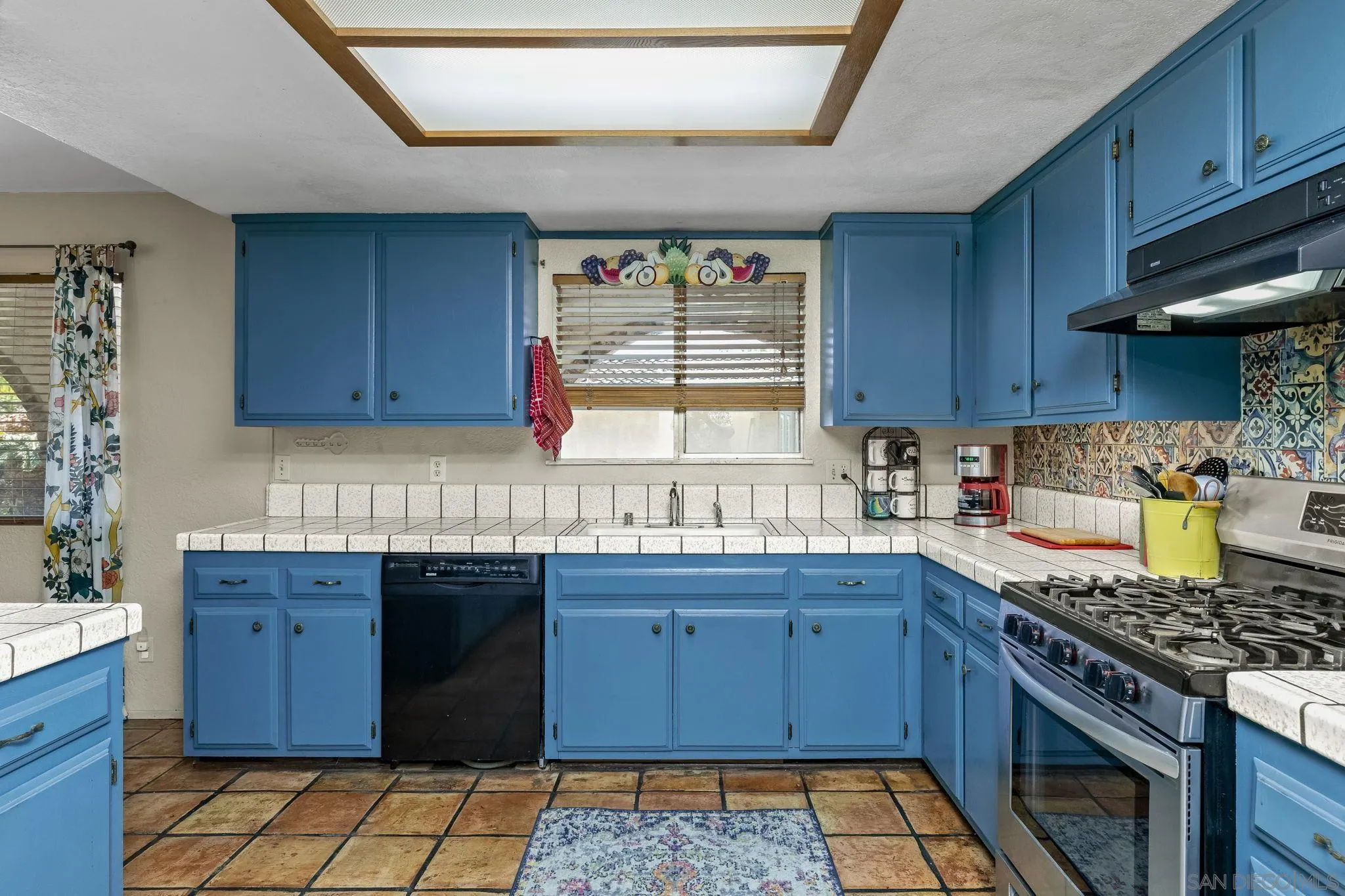 244 Avalon Drive Vista, CA 92084 - Photo 8 of 23 a kitchen with a stove sink and cabinets