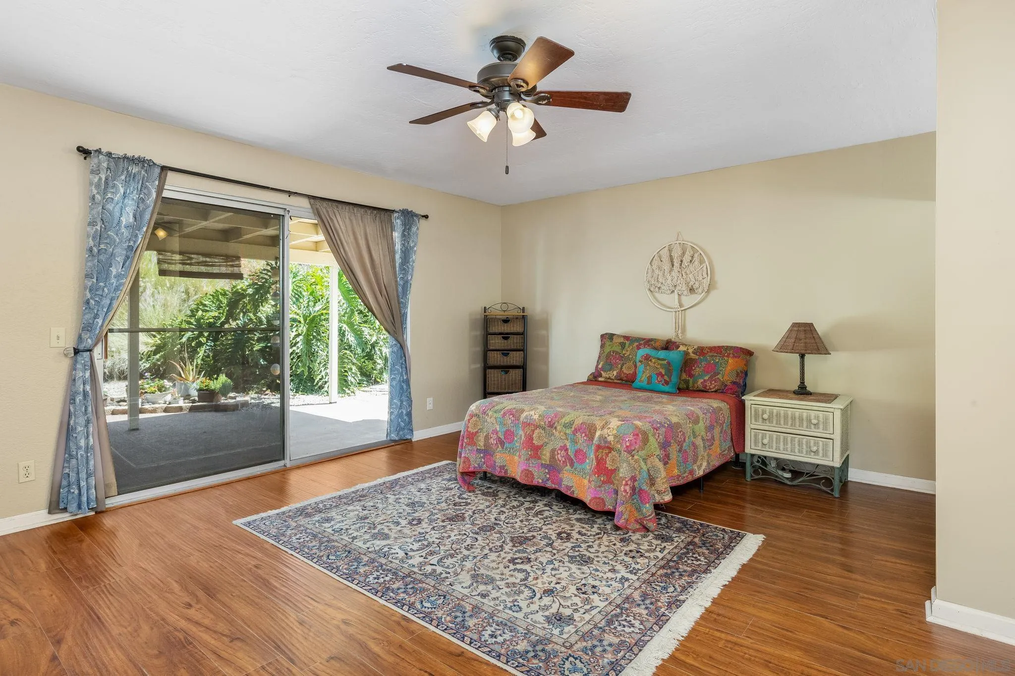 244 Avalon Drive Vista, CA 92084 - Photo 9 of 23 a bedroom with a bed rug and wooden floor