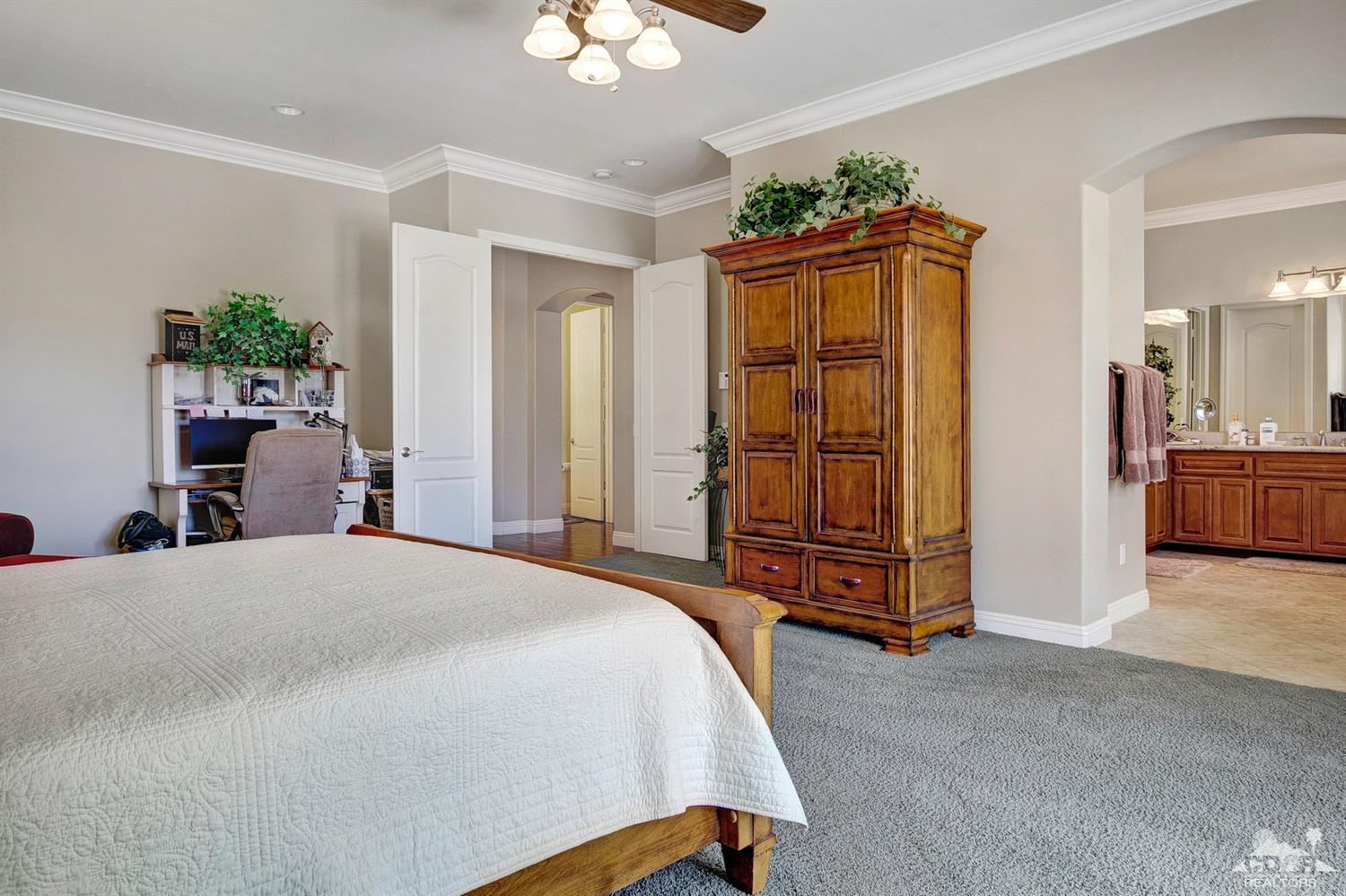 60266 Hop Patch Spring Road Mountain Center, CA 92561 - Photo 22 of 41 a bedroom with a bed and a chandelier