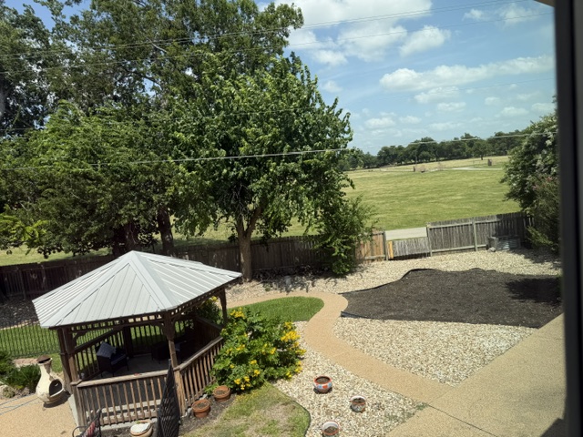 13 Oak View Round Rock, TX 78664 - Photo 27 of 30 A private backyard oasis with a charming gazebo and views of a verdant field.