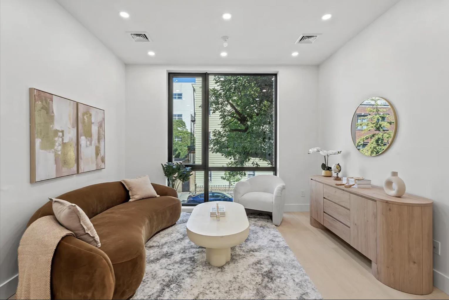 204 Withers Street, Unit 2 Brooklyn, NY 11211 - Photo 2 of 8 a living room with furniture and a large window