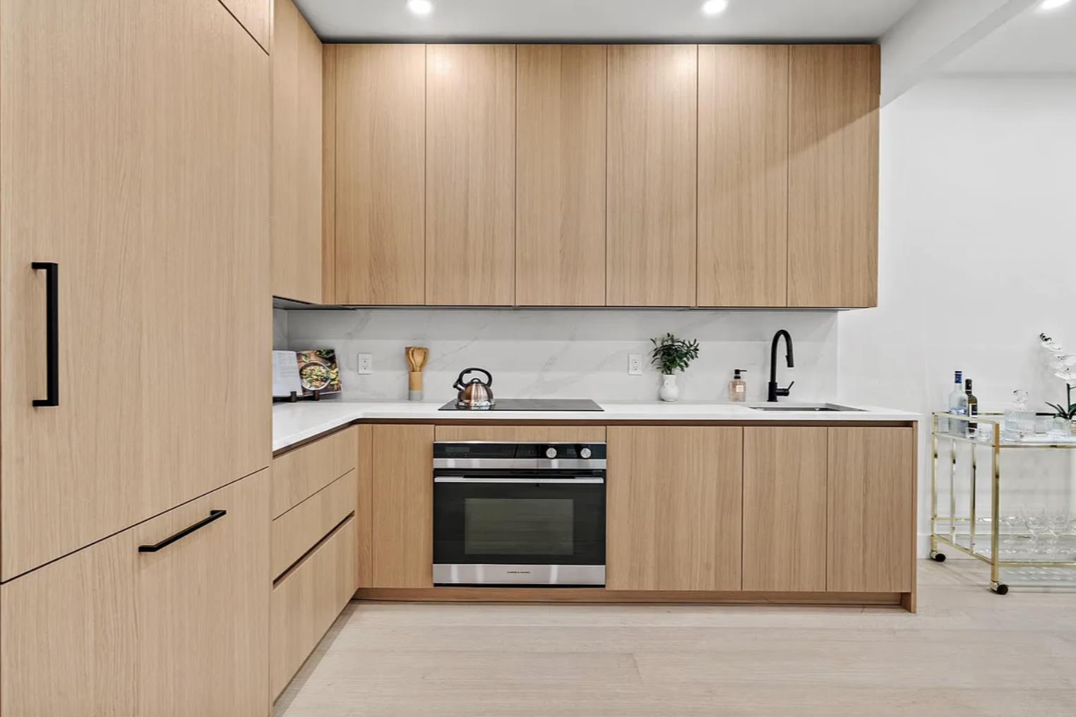204 Withers Street, Unit 2 Brooklyn, NY 11211 - Photo 4 of 8 a kitchen with stainless steel appliances granite countertop a stove a sink and white cabinets