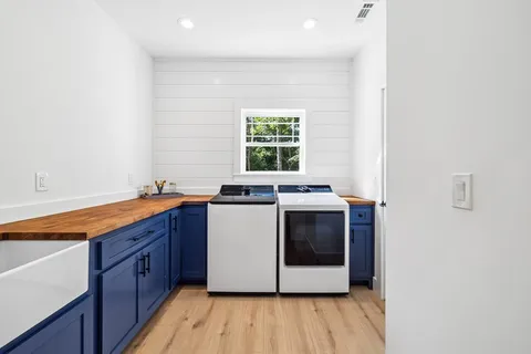 a kitchen with white cabinets a sink and dishwasher