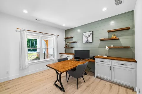 a bed sitting in a bedroom next to a window