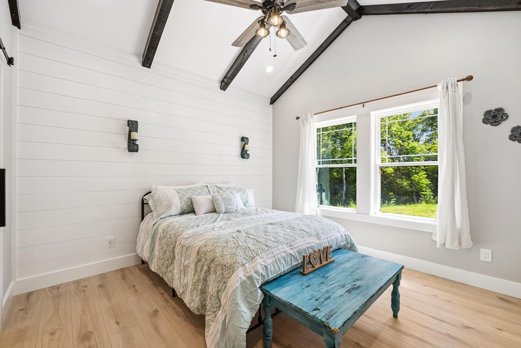 60 Buckeye Branch Road Morganton, GA 30560 - Photo 31 of 54 a bedroom with a bed and wooden floor