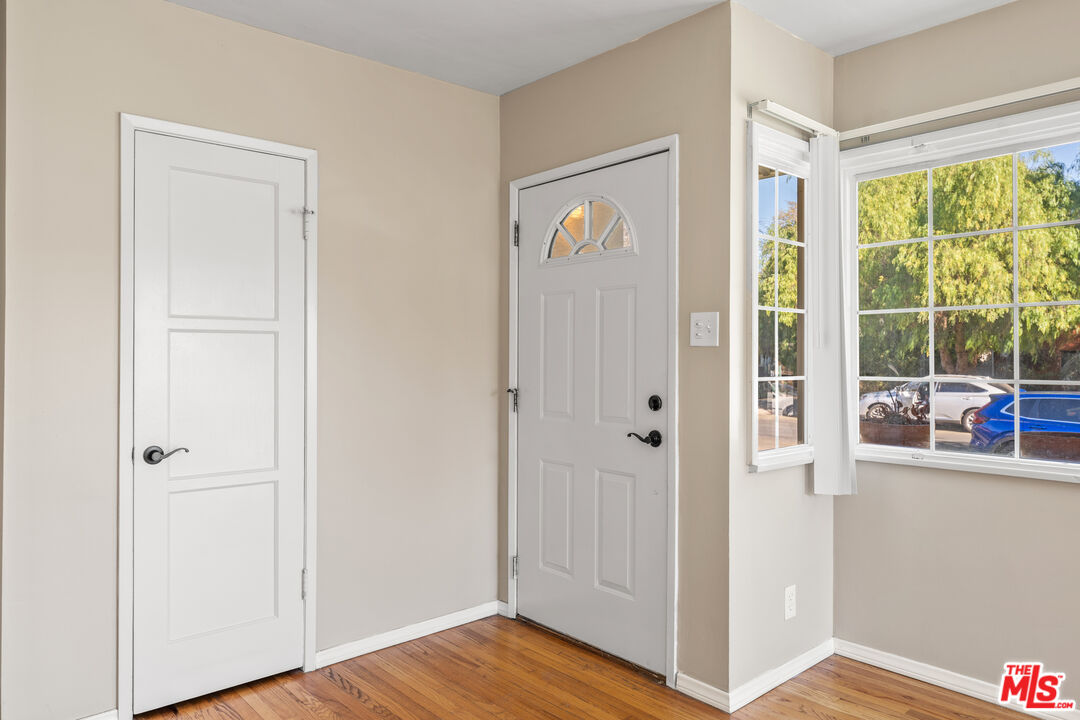 6327 Ranchito Avenue Valley Glen, CA 91401 - Photo 14 of 46 a view of a hallway with wooden floor and front door