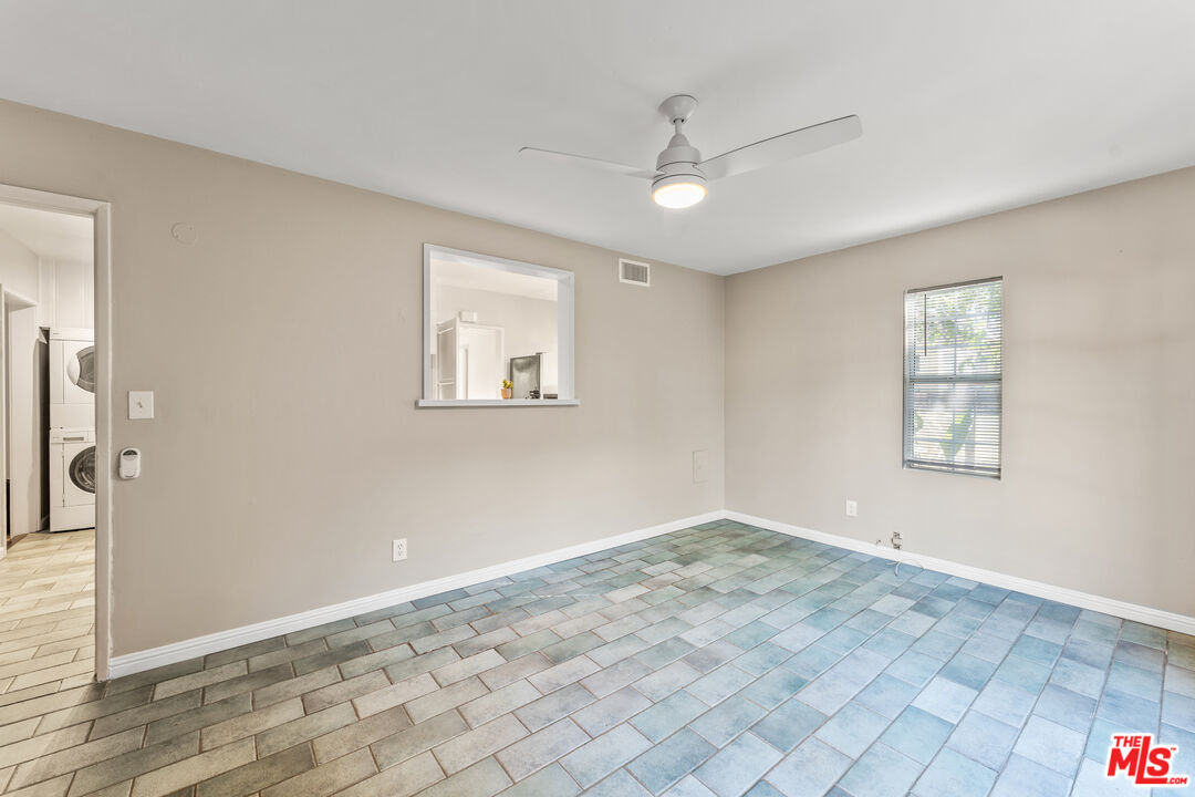 6327 Ranchito Avenue Valley Glen, CA 91401 - Photo 16 of 46 an empty room with windows and fan