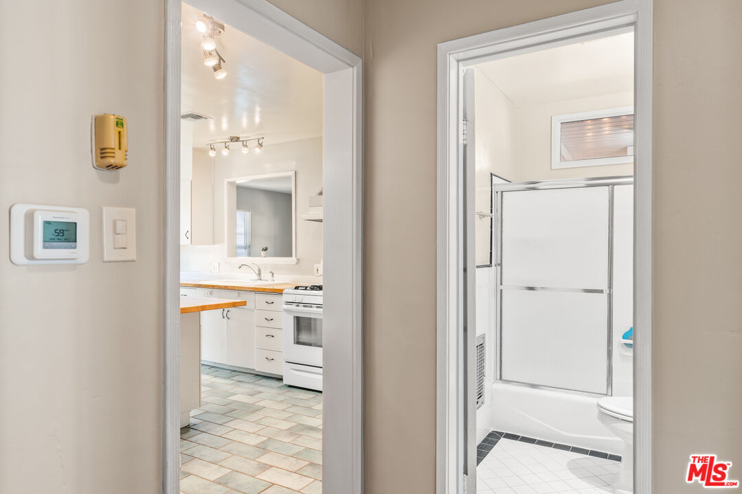 6327 Ranchito Avenue Valley Glen, CA 91401 - Photo 19 of 46 a bathroom with a granite countertop sink mirror and a
