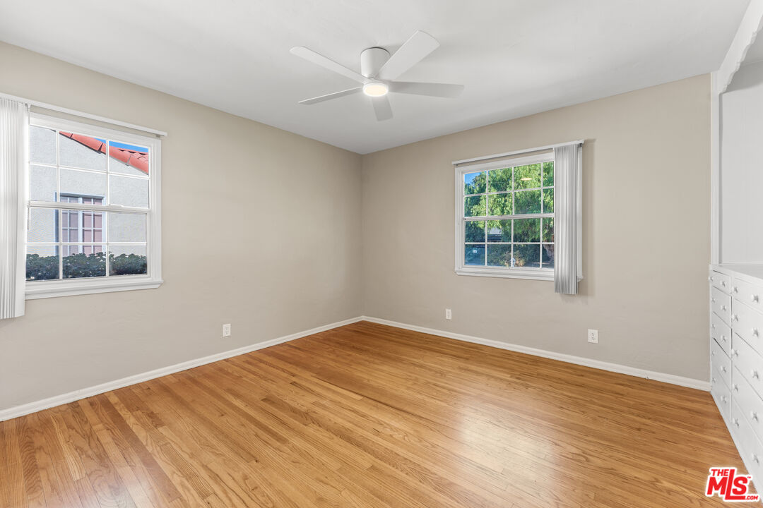 6327 Ranchito Avenue Valley Glen, CA 91401 - Photo 23 of 46 a view of empty room with wooden floor and fan