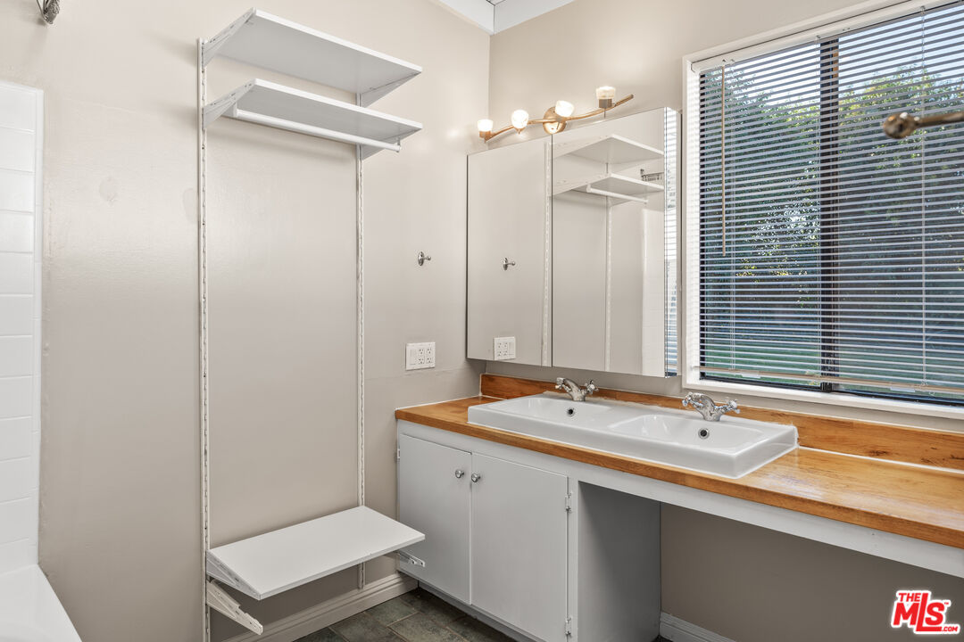 6327 Ranchito Avenue Valley Glen, CA 91401 - Photo 28 of 46 a bathroom with a sink a toilet a mirror and shower