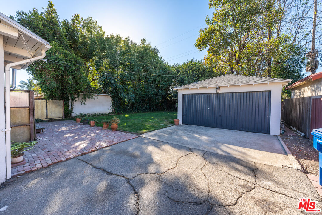 6327 Ranchito Avenue Valley Glen, CA 91401 - Photo 41 of 46 a front view of a house with a yard and a garage
