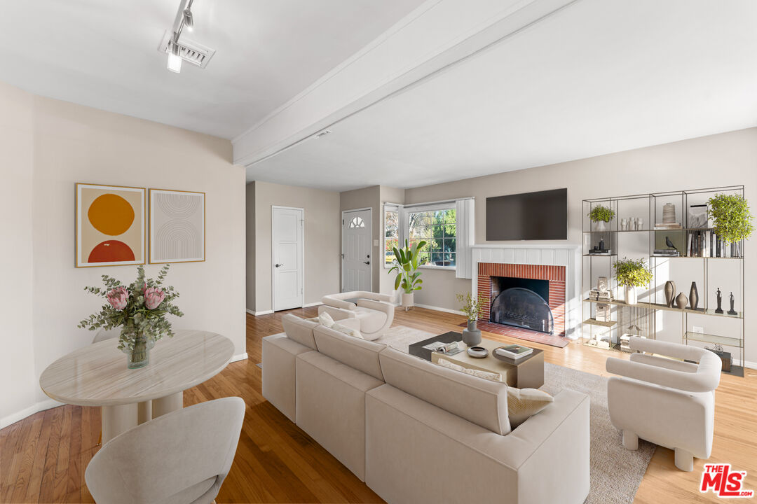 6327 Ranchito Avenue Valley Glen, CA 91401 - Photo 6 of 46 a living room with furniture a fireplace and a table
