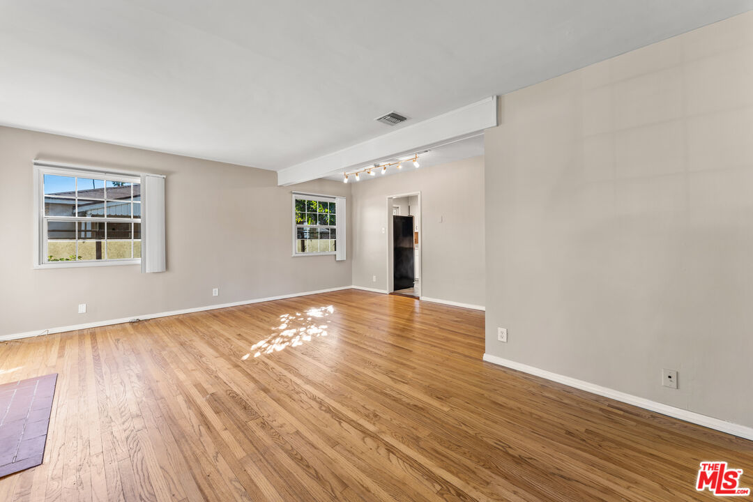 6327 Ranchito Avenue Valley Glen, CA 91401 - Photo 7 of 46 a view of empty room with wooden floor and fan