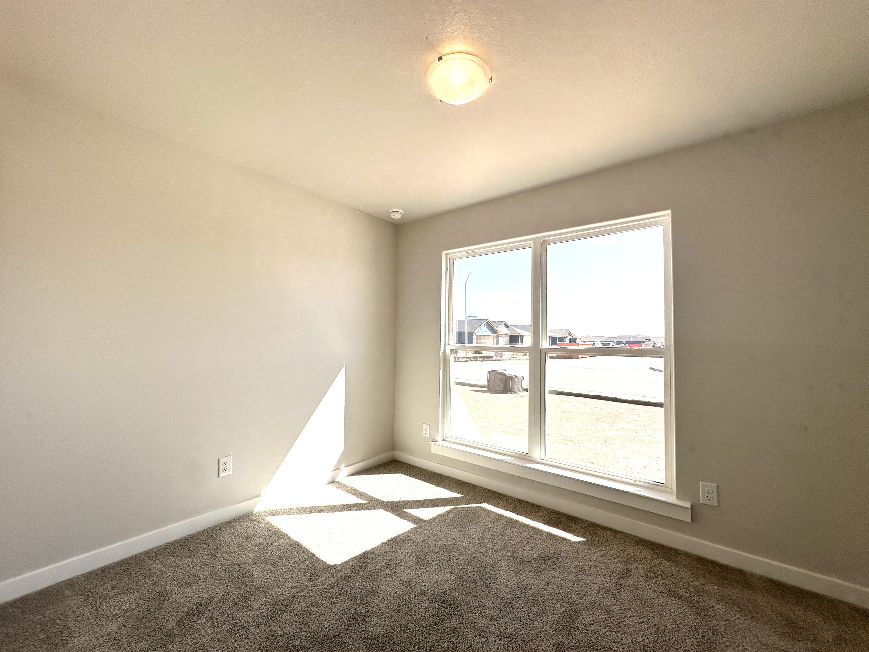 5528 Princeton Street Lubbock, TX 79416 - Photo 5 of 10 an empty room with windows