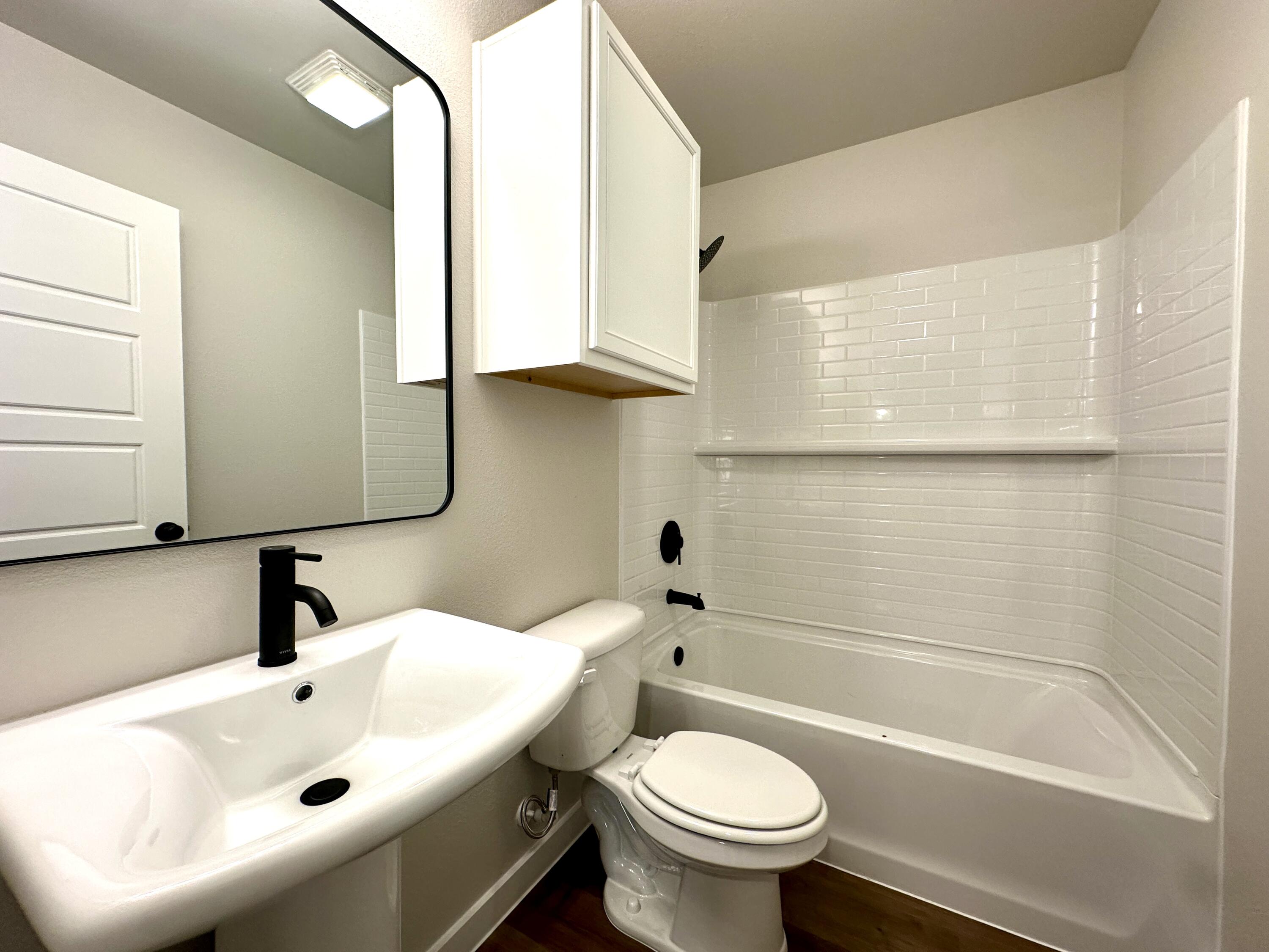 5528 Princeton Street Lubbock, TX 79416 - Photo 6 of 10 a bathroom with a sink a toilet and bathtub
