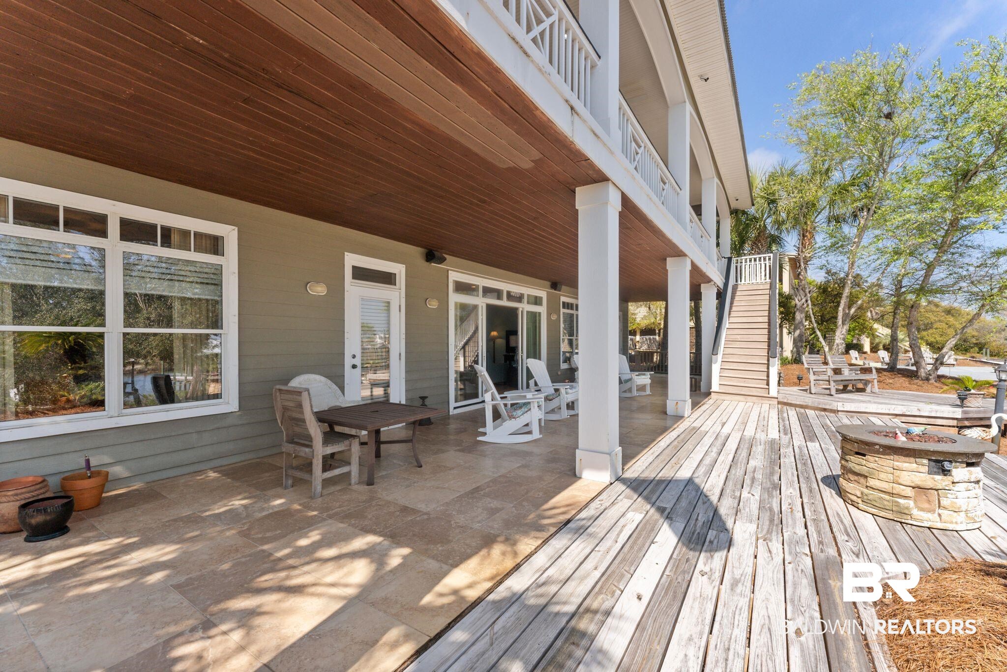 30818 River Road Orange Beach, AL 36561 - Photo 10 of 81 Deck with outdoor dining area and an outdoor fire pit