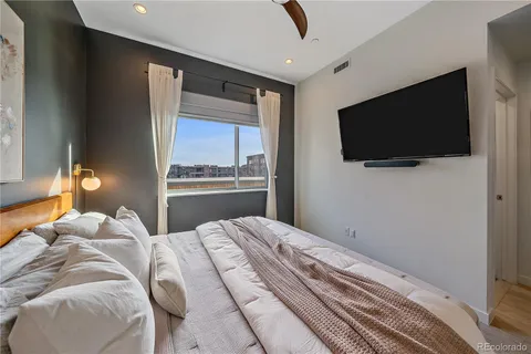 a bedroom with a large bed and a flat screen tv