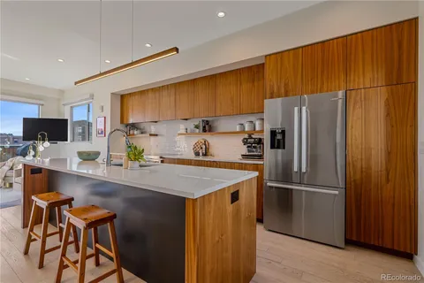 a kitchen with stainless steel appliances a refrigerator and a stove top oven