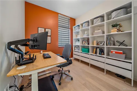 a view of a workspace with furniture and a window