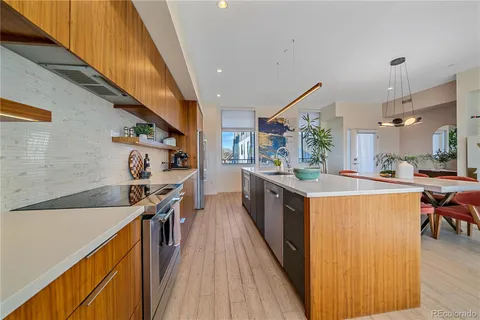 a kitchen with stainless steel appliances granite countertop sink stove top oven and cabinets