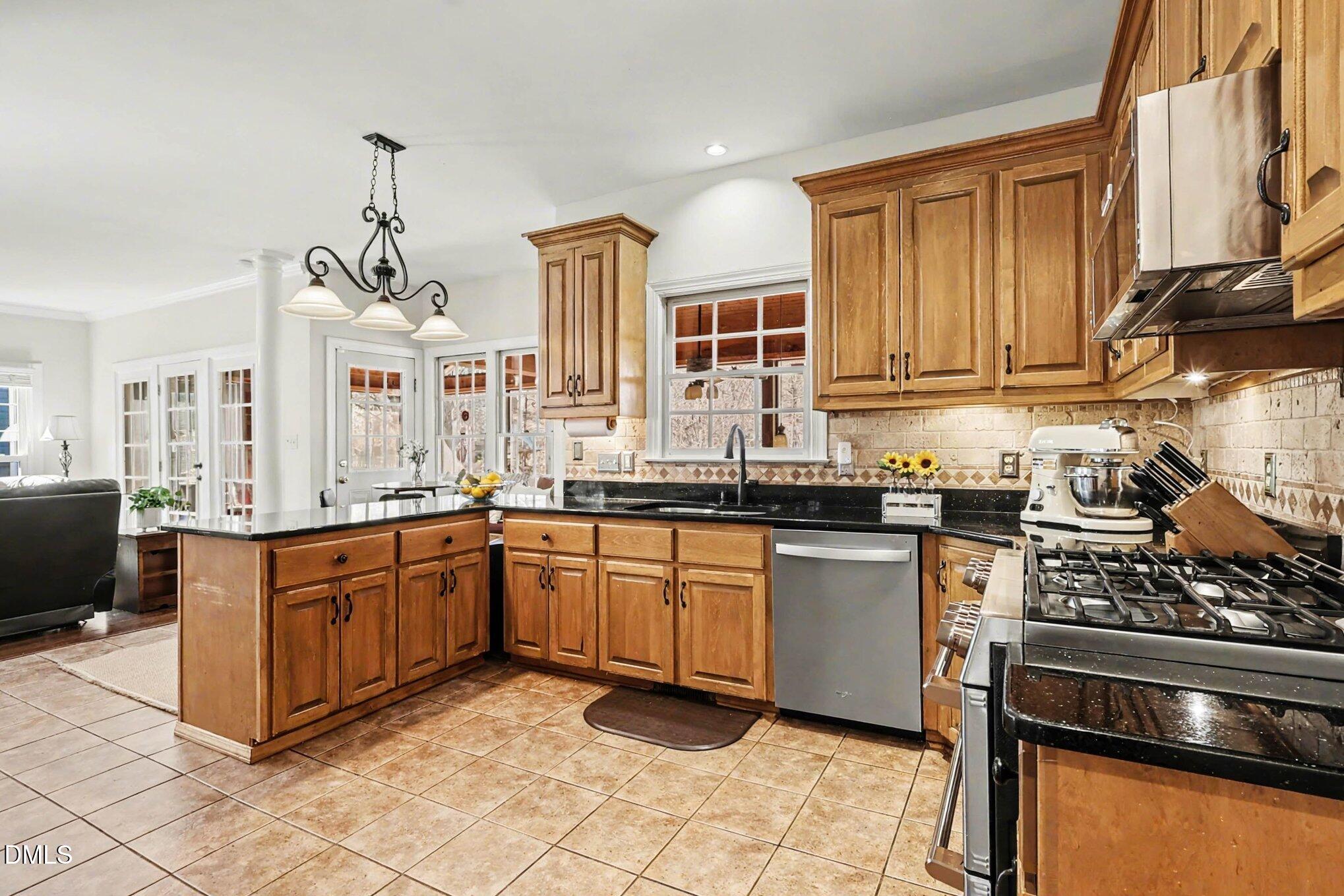 119 Felspar Way Cary, NC 27518 - Photo 14 of 53 a kitchen with stainless steel appliances granite countertop a stove a sink and a refrigerator