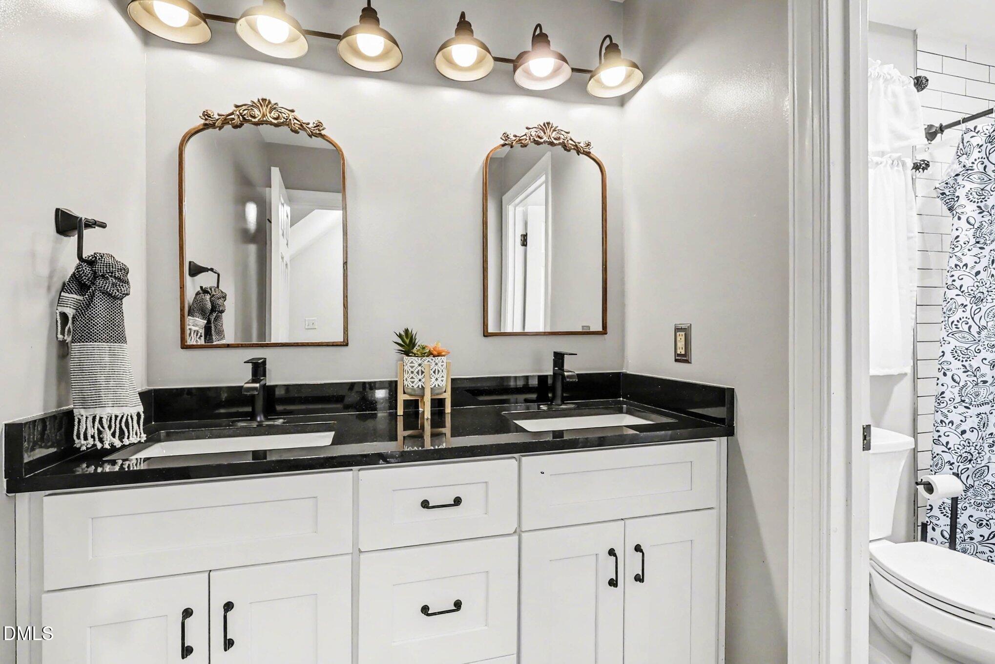 119 Felspar Way Cary, NC 27518 - Photo 20 of 53 a bathroom with a double vanity sink and a mirror
