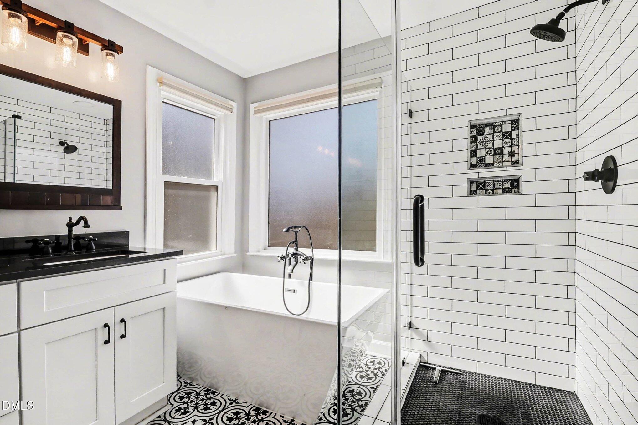 119 Felspar Way Cary, NC 27518 - Photo 21 of 53 a bathroom with a sink a mirror and shower