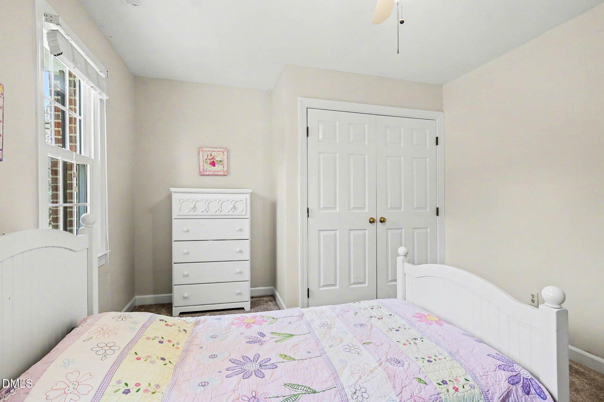119 Felspar Way Cary, NC 27518 - Photo 23 of 53 a bedroom with a bed and a window