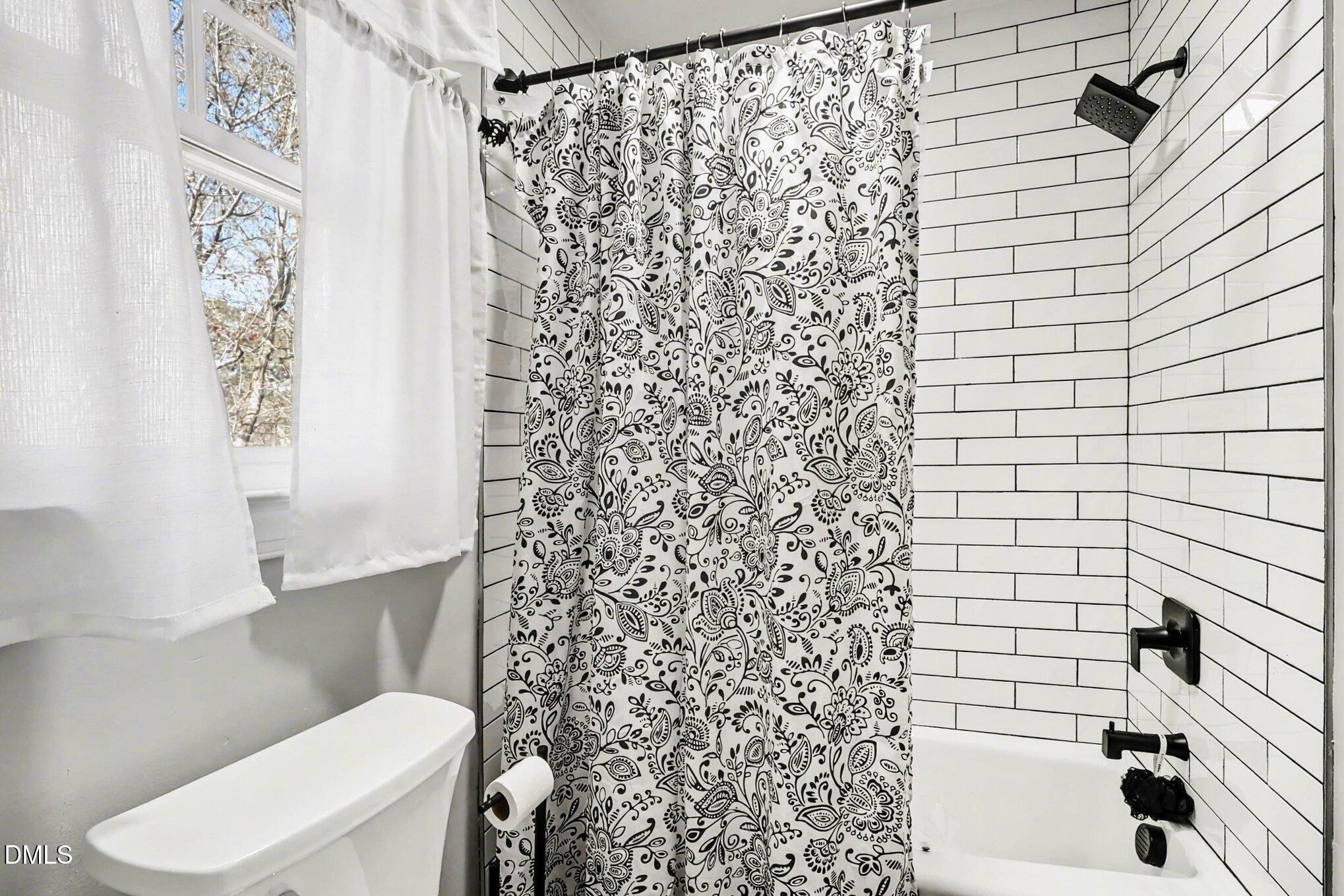 119 Felspar Way Cary, NC 27518 - Photo 26 of 53 a bathroom with a toilet and a shower curtain