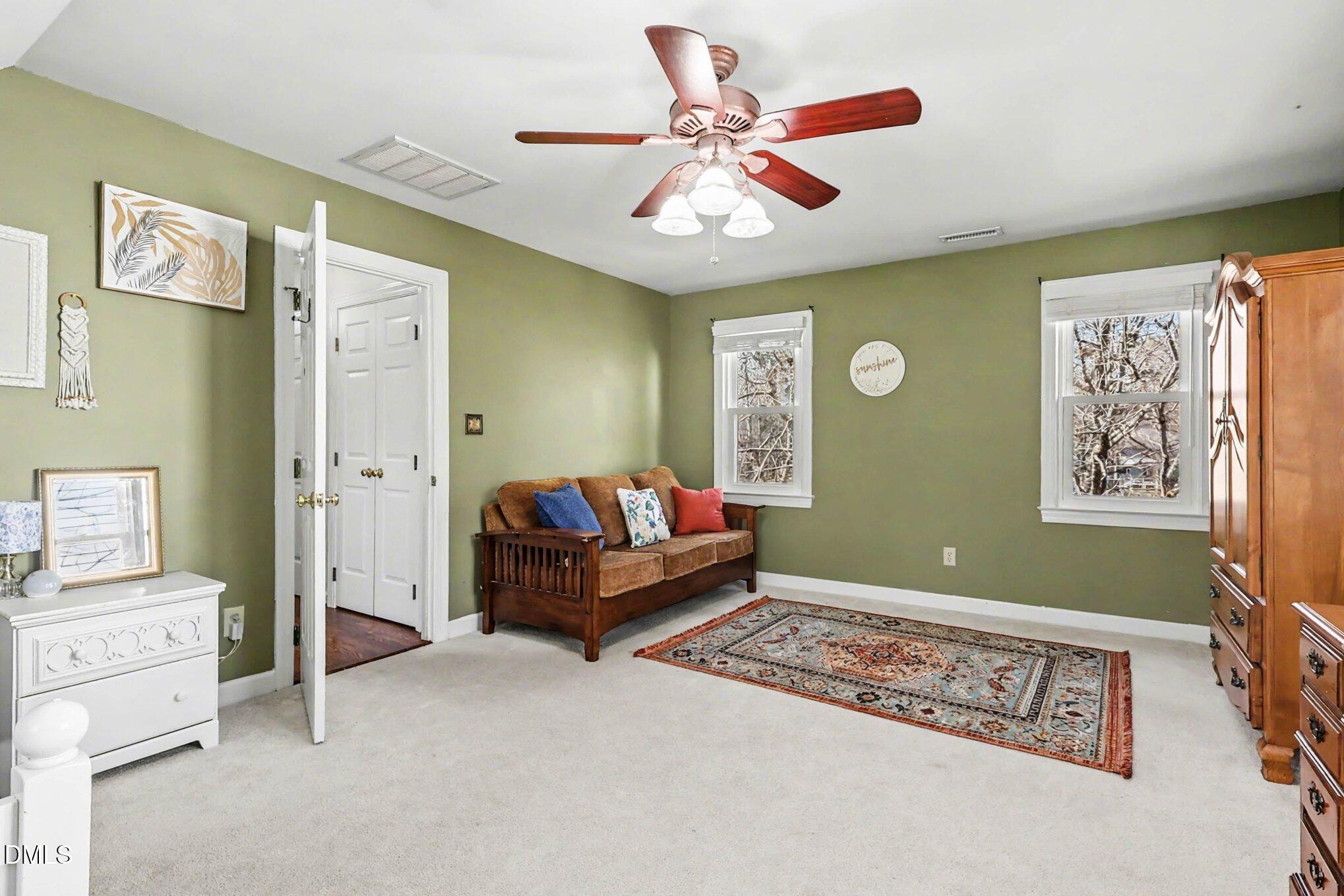 119 Felspar Way Cary, NC 27518 - Photo 28 of 53 a bedroom with furniture and a chandelier