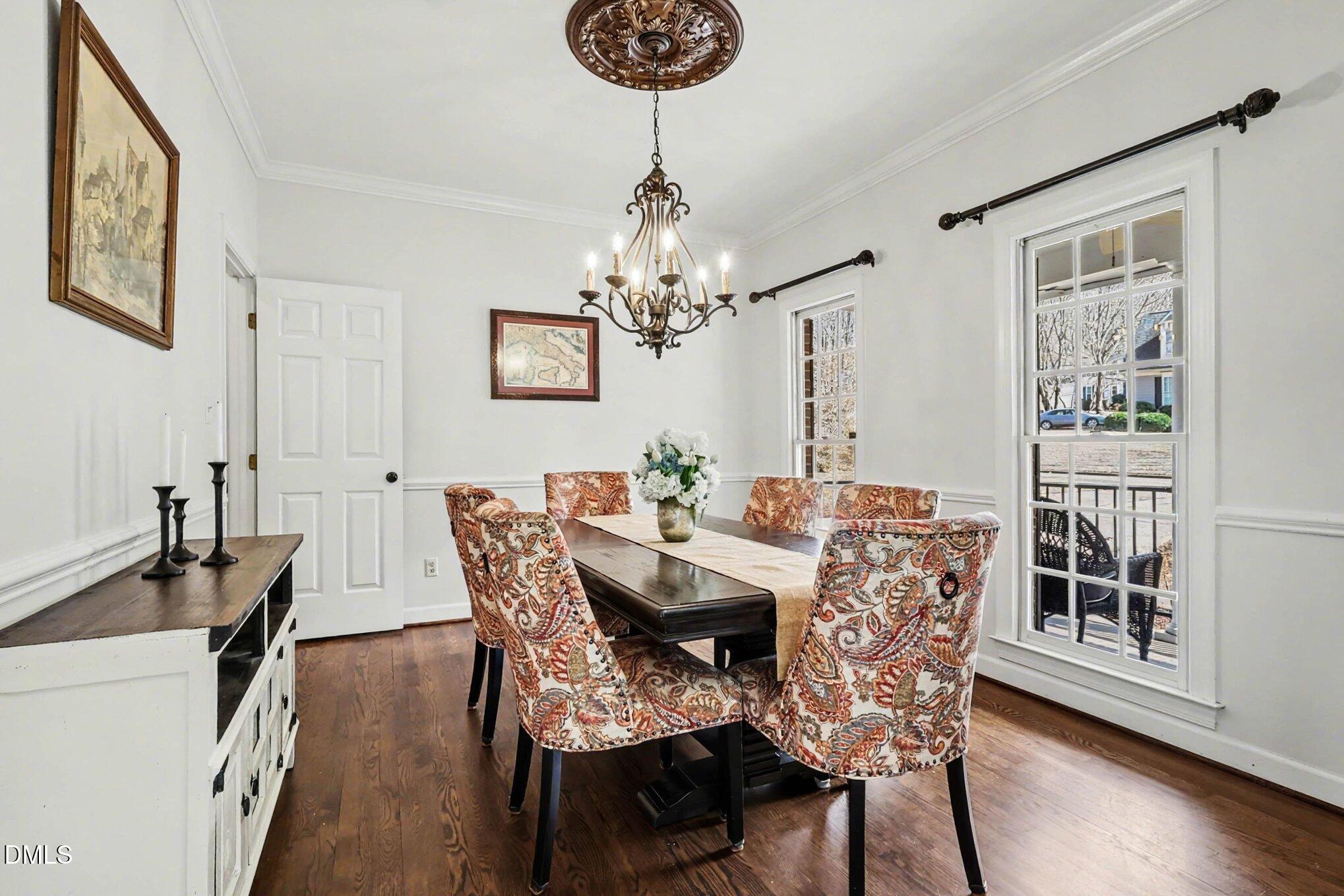119 Felspar Way Cary, NC 27518 - Photo 10 of 53 a view of a dining room with furniture window and wooden floor