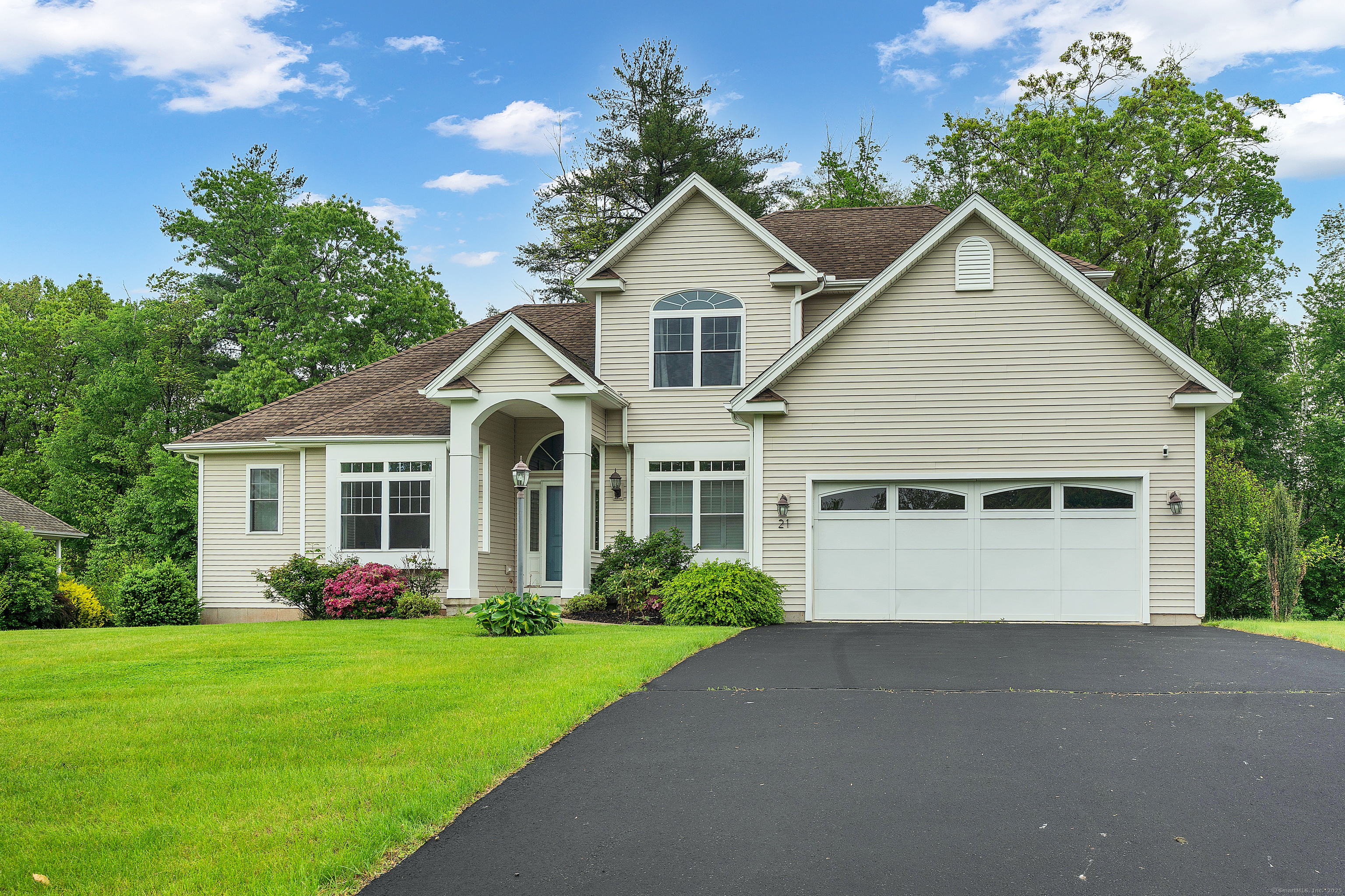 a front view of house with yard and green space