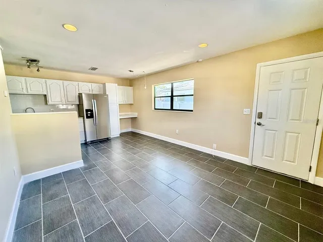 a view of a livingroom with an empty space and a window