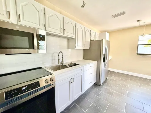 a kitchen with stainless steel appliances granite countertop a stove and a refrigerator