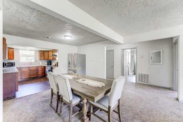 a living room with furniture a table and chairs