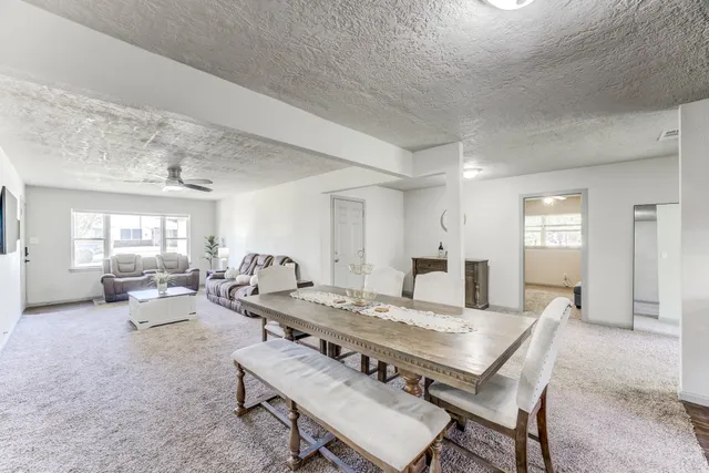 a kitchen with stainless steel appliances granite countertop wooden cabinets a stove top oven a sink and dishwasher with wooden floor