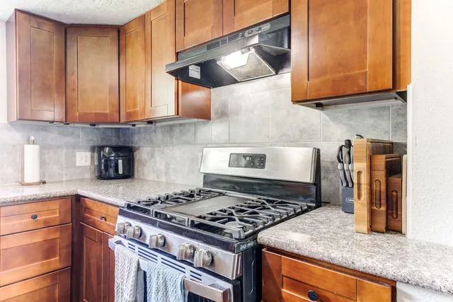 a kitchen with granite countertop a sink and a window