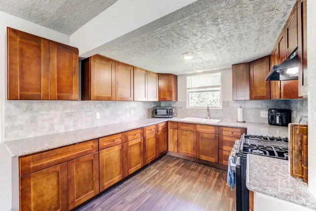 an empty room with windows and cabinet