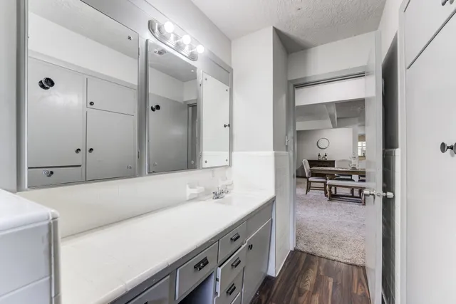 a bedroom with a bed a chandelier and a window