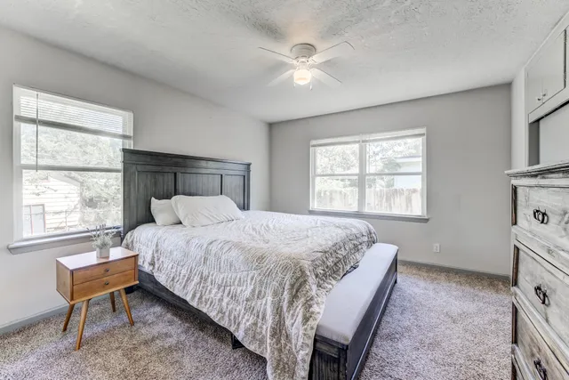 a bedroom with a bed and a window