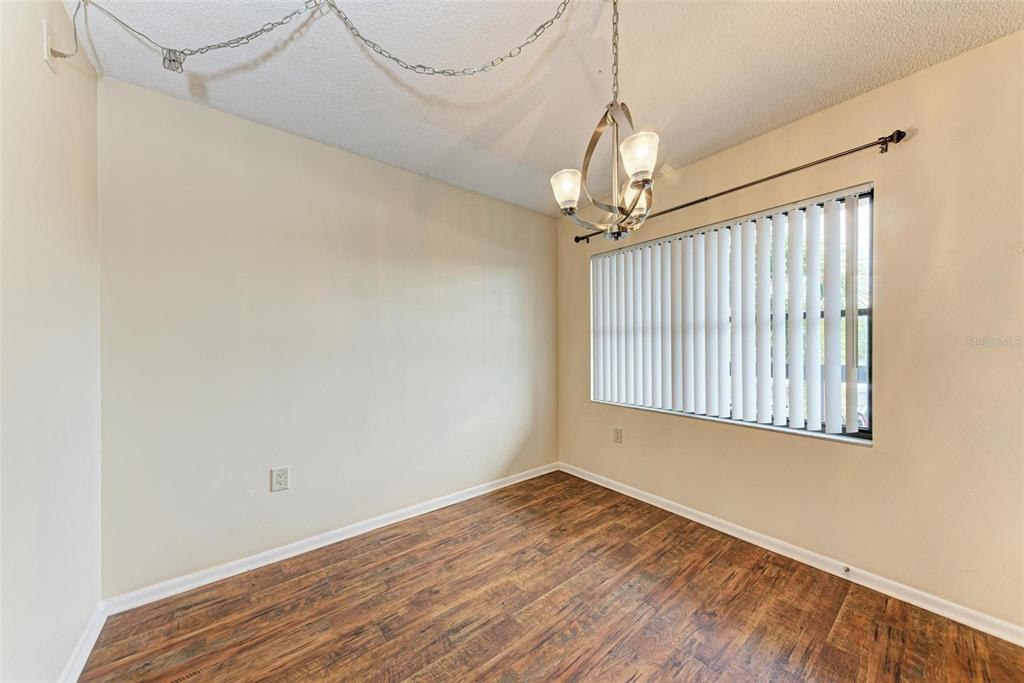 305 30th Avenue West, Unit A210 Bradenton, FL 34205 - Photo 11 of 33 a view of a room with wooden floor fan and windows