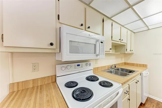 a kitchen with cabinets and appliances