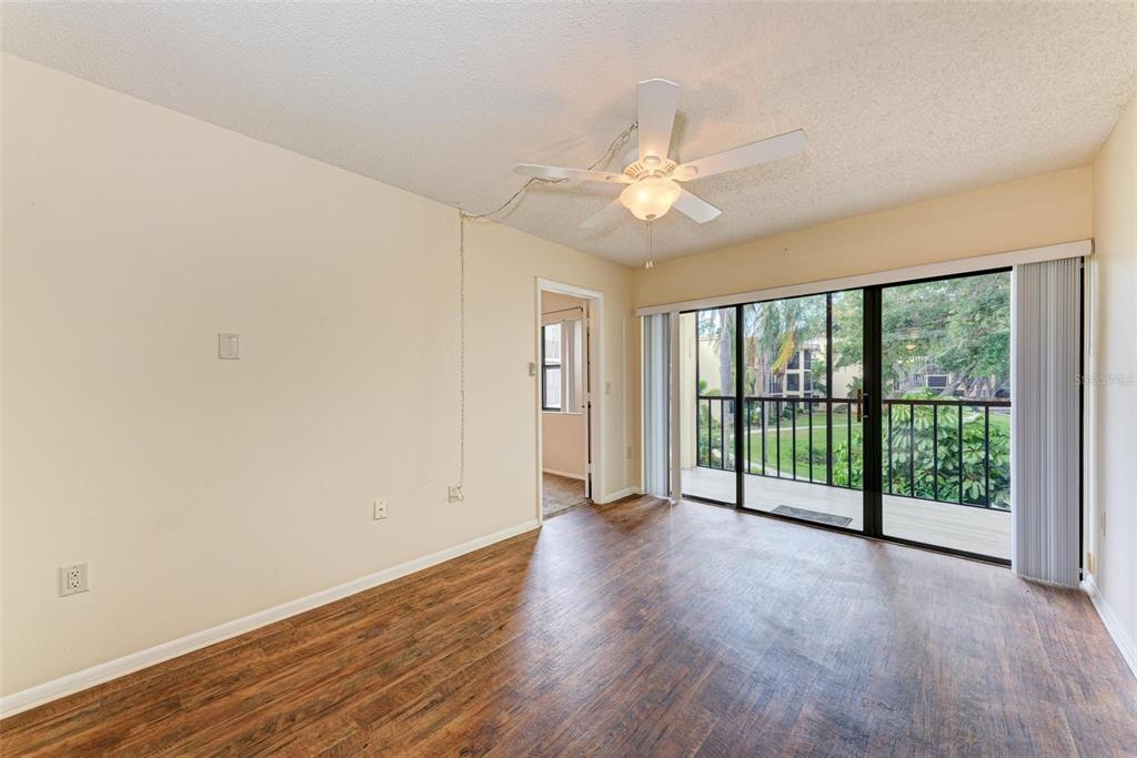 305 30th Avenue West, Unit A210 Bradenton, FL 34205 - Photo 17 of 33 wooden floor in an empty room with a window