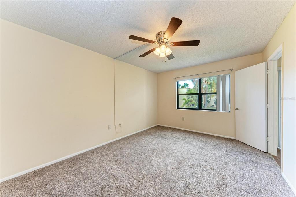 305 30th Avenue West, Unit A210 Bradenton, FL 34205 - Photo 21 of 33 an empty room with windows and fan