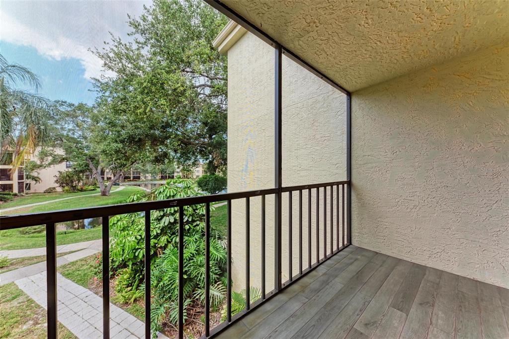 305 30th Avenue West, Unit A210 Bradenton, FL 34205 - Photo 28 of 33 a view of a balcony with wooden floor