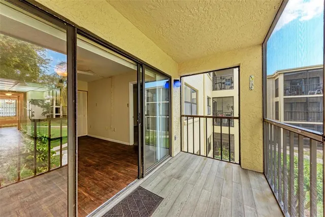 a view of a porch with wooden floor and outdoor space