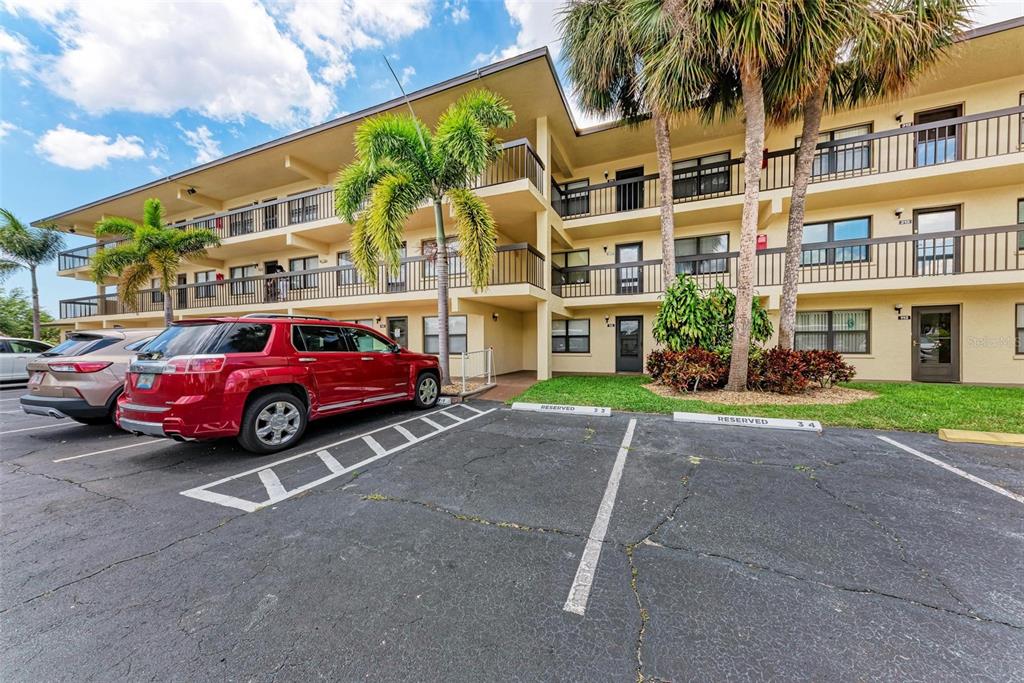 305 30th Avenue West, Unit A210 Bradenton, FL 34205 - Photo 31 of 33 a view of a cars park in front of a building