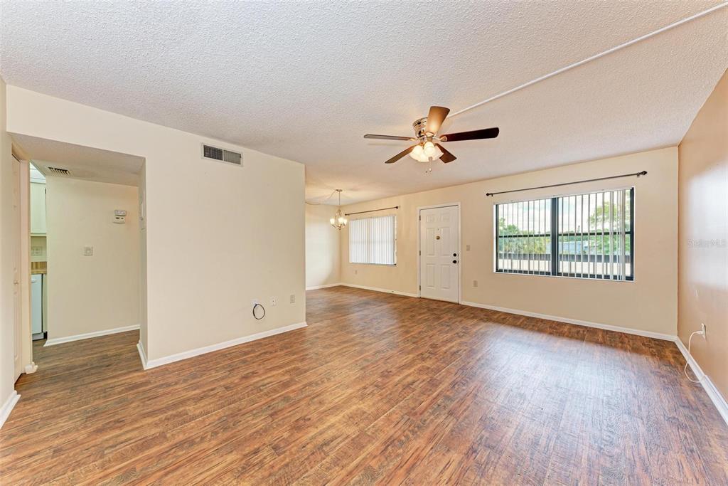 305 30th Avenue West, Unit A210 Bradenton, FL 34205 - Photo 4 of 33 wooden floor in an empty room with a window