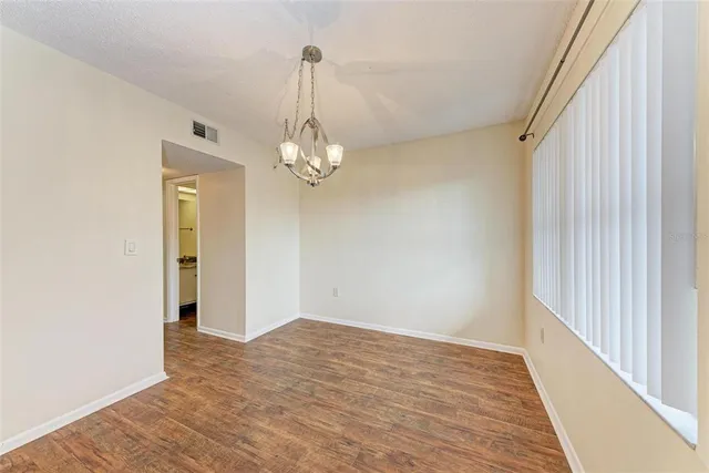 a view of a livingroom with wooden floor and staircase