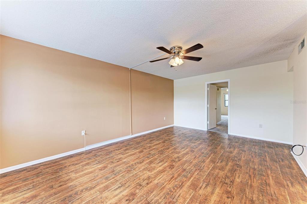 305 30th Avenue West, Unit A210 Bradenton, FL 34205 - Photo 9 of 33 a view of an empty room with wooden floor